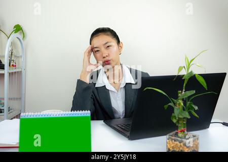 Attractive Asian Chinese Female Young Manager in Formal Dress in Office Gives Gestures Wow Happy with Calendar Mockup Stock Photo