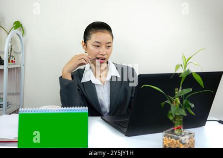 Attractive Asian Chinese Female Young Manager in Formal Dress in Office Gives Gestures Wow Happy with Calendar Mockup Stock Photo