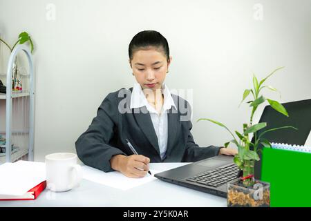 Attractive Asian Chinese Female Young Manager in Formal Dress in Office Gives Gestures Wow Happy with Calendar Mockup Stock Photo