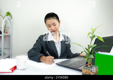 Attractive Asian Chinese Female Young Manager in Formal Dress in Office Gives Gestures Wow Happy with Calendar Mockup Stock Photo