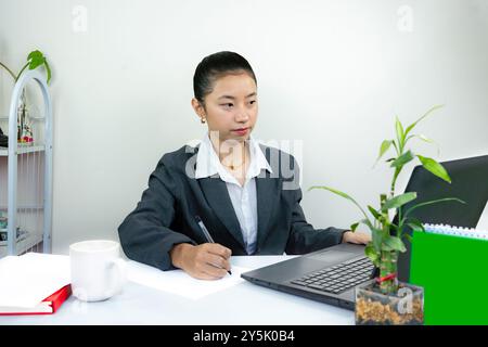 Attractive Asian Chinese Female Young Manager in Formal Dress in Office Gives Gestures Wow Happy with Calendar Mockup Stock Photo