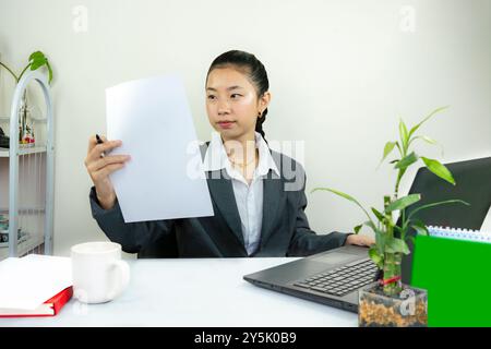 Attractive Asian Chinese Female Young Manager in Formal Dress in Office Gives Gestures Wow Happy with Calendar Mockup Stock Photo