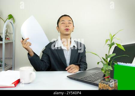 Attractive Asian Chinese Female Young Manager in Formal Dress in Office Gives Gestures Wow Happy with Calendar Mockup Stock Photo