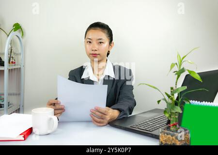 Attractive Asian Chinese Female Young Manager in Formal Dress in Office Gives Gestures Wow Happy with Calendar Mockup Stock Photo