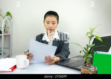 Attractive Asian Chinese Female Young Manager in Formal Dress in Office Gives Gestures Wow Happy with Calendar Mockup Stock Photo