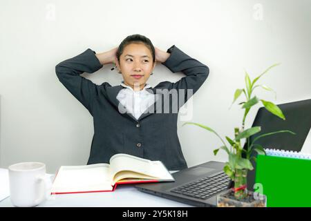 Attractive Asian Chinese Female Young Manager in Formal Dress in Office Gives Gestures Wow Happy with Calendar Mockup Stock Photo