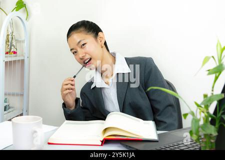 Attractive Asian Chinese Female Young Manager in Formal Dress in Office Gives Gestures Wow Happy with Calendar Mockup Stock Photo