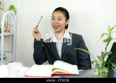 Attractive Asian Chinese Female Young Manager in Formal Dress in Office Gives Gestures Wow Happy with Calendar Mockup Stock Photo