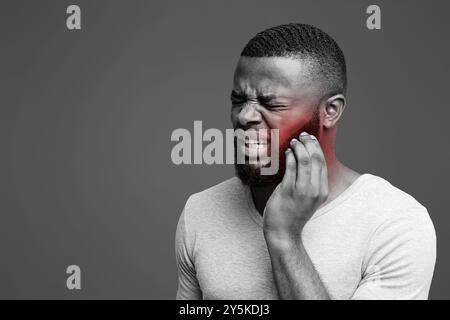 Young afro man having wisdom teeth problem Stock Photo