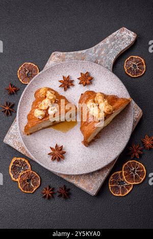 Sweet crispy croissant with salted caramel and glazed popcorn on a dark textured background Stock Photo