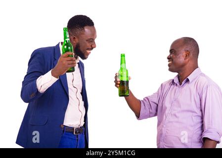 two adult business partners talking together with each a beer bottle in hand while smiling Stock Photo