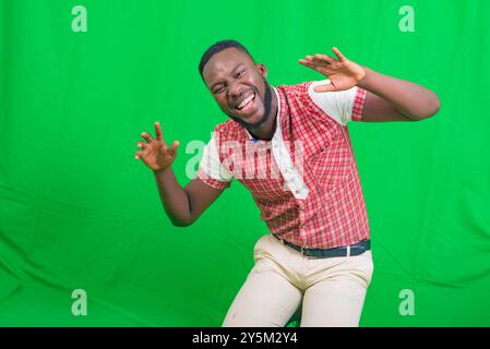 portrait of a happy handsome young man making funny faces with both hands while smiling. Stock Photo