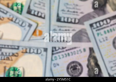 Soft focus, blurry 100 dollar bills. Debt, savings, finances and economy concept. Stock Photo