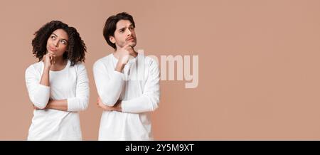 Portrait of pensive interracial couple thinking about something and looking away Stock Photo