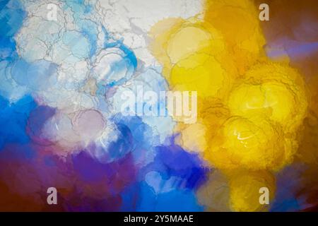 This vibrant abstract image features a blend of blue, yellow, and purple watercolor hues, creating a dynamic and captivating visual experience, ideal Stock Photo
