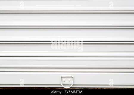 White roller shutter metallic garage door as background and copy space Stock Photo