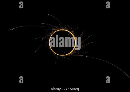 Circular lights with sparks on a black background Stock Photo