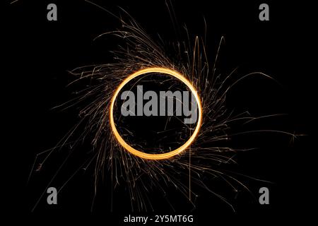 Circular lights with sparks on a black background Stock Photo