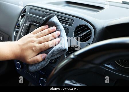 Man cleaning center console with rag, closeup Stock Photo - Alamy