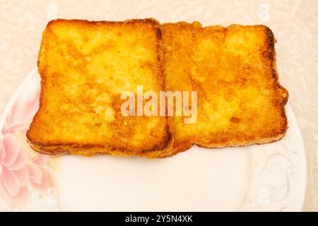 Golden brown french toast on a flower plate. Stock Photo