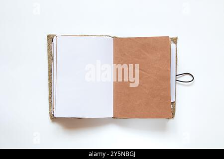Open homemade notebook made of fabric and lace and different pages on white background, handmade notebook Stock Photo