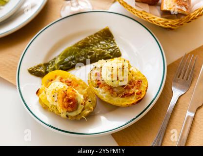 Twice baked potatoes stuffed with meat, jam, cheese and egg Stock Photo