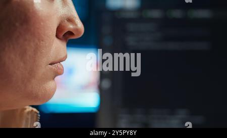 Extreme closer up shot of happy computer engineer satisfied after futureproofing company network from system failures. Smiling IT worker pleased after managing to increase data security, camera B Stock Photo