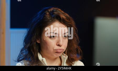 Upset teleworking engineer worried after failing to secure company servers from virus attacks, close up. Anxious woman stressed about being unable to build firewalls protecting data, camera A Stock Photo