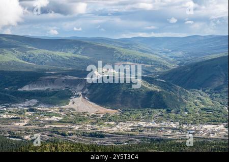 Overview of the Ogilvie Mountains and a gold mine as seen from Midnight Dome at Dawson City, Yukon, Canada Stock Photo