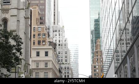 New York City Manhattan Midtown building architecture, urban street in United States. American residential and business real estate on 5th Fifth 5 avenue in USA. Saint Thomas church. Stock Photo