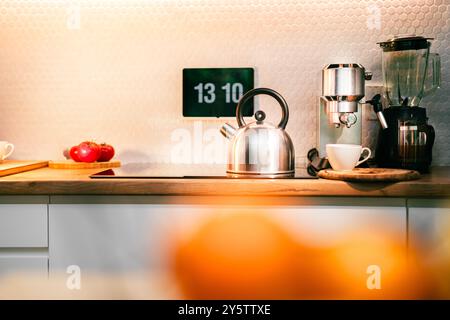 Water kettle. Home kitchen interior. Screen with digital clock home control. Stock Photo