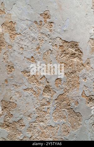 Close-up view of the wall paint peeling off and mold on the wall. Stock Photo