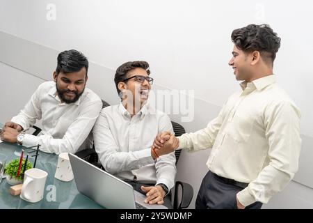 Indian Gen Z office culture or modern businessman are captured in a moment of joy and camaraderie at their workplace making the working ambience happy Stock Photo