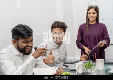Indian Office Team Staff Collaboration in a Modern Workspace. This image beautifully captures the essence of positive and energetic teamwork in a cont Stock Photo
