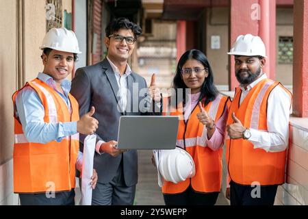 A skilled team of engineers is engaged in maintenance and training activities within a factory workshop The team’s expertise in mechanical engineering Stock Photo