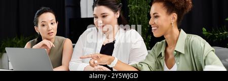A vibrant discussion among three elegant businesswomen working in an office space. Stock Photo