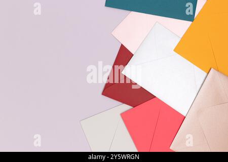 Multicolored envelopes scattered on a blue background. Creative concept with copyspace. Stock Photo
