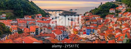 A wide 3:1 panoramic photo of an evening at sunset in Cudillero, a picturesque little fishing village located on the coast of Asturias, the 'Costa Ver Stock Photo