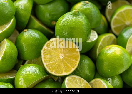 Lime cut on blurred background of several lime greens in top view Stock Photo