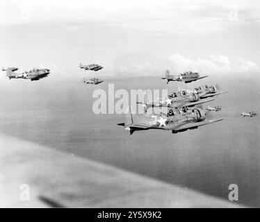 Vintage photo circa July 20 1943 of a flight of American Douglas SBD Dauntless dive bombers attacking the Japanese base at Rekata Bay, Santa Isabel Island, in the Solomon Islands during world war two Stock Photo