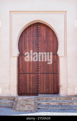 Traditional Moroccan ancient wooden entry door. In the old Medina in Marrakech, Morocco. Typical, old, wooden, Moroccan door. Stock Photo