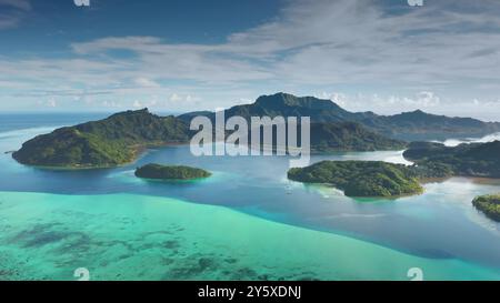 Aerial view tropical landscape green islands archipelago coral barrier reef turquoise water lagoon. Breathtaking beauty of French Polynesia. Stunning travel paradise, perfect exotic summer vacation Stock Photo