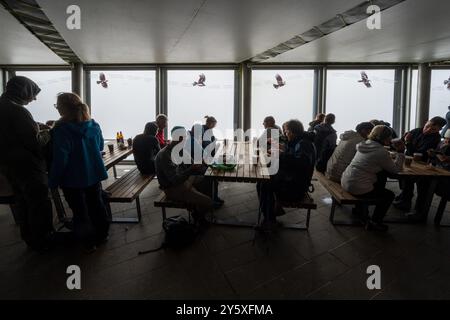 The interior of the cafe at the summit station on the Snowdon Mountain Railway in North Wales. Hafod Eryri the Summit visitor centre. The customers ha Stock Photo