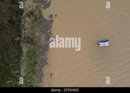 The open boot of a car is visible above the water where the vehicle is submerged in flood water on a421 in Marston Moretaine, Bedfordshire. Parts of Britain have been struck by flash floods after some areas saw more than a month's worth of rain in 24 hours. Heavy rainfall has seen parts of Northamptonshire, Bedfordshire and London submerged causing widespread travel disruption and damage to properties. Picture date: Monday September 23, 2024. Stock Photo