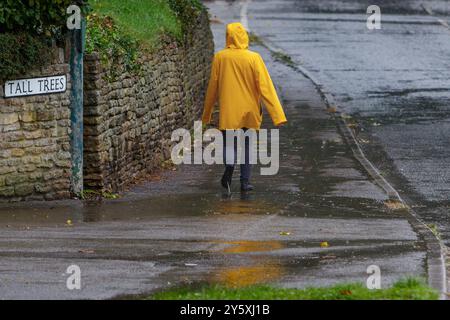 Chippenham, Wiltshire, UK, 23rd Sep, 2024. A woman walking into Chippenham town centre is pictured braving heavy rain in Chippenham as torrential showers make their way across Southern England.Credit: Lynchpics/Alamy Live News Stock Photo