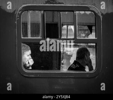 Passengers in a carriage experiencing the Watercress Line whilst the train is stationary. Stock Photo