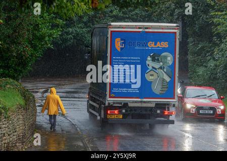 Chippenham, Wiltshire, UK, 23rd Sep, 2024. A woman walking into Chippenham town centre is pictured braving heavy rain in Chippenham as torrential showers make their way across Southern England.Credit: Lynchpics/Alamy Live News Stock Photo
