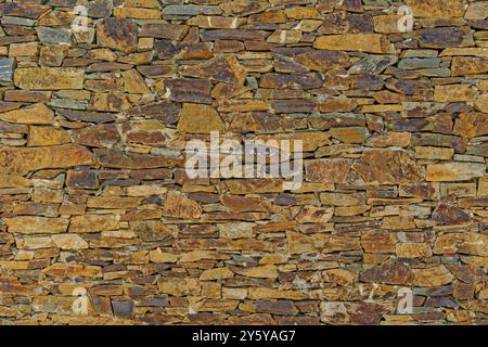 Rustic stone wall facia. Stock Photo