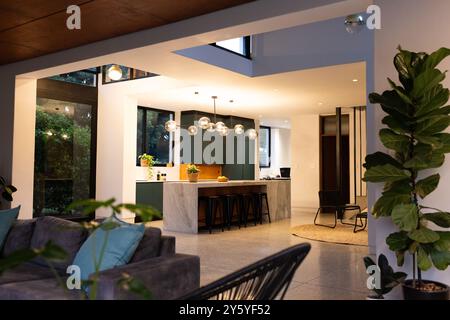 Modern kitchen with marble island and bar stools in stylish open-plan home, copy space Stock Photo