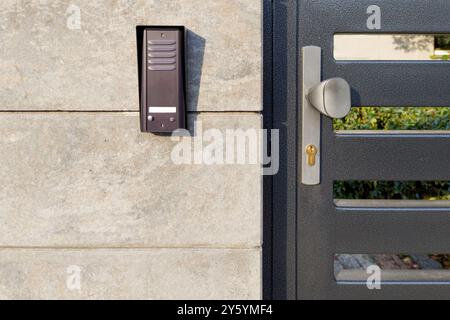 Metal gate with security intercom system Stock Photo
